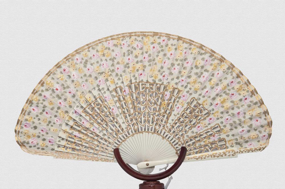 Ivory lacquered wood fan and polished back.